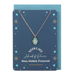 Hamsa necklace and star-themed greeting card set with matching turquoise envelope.