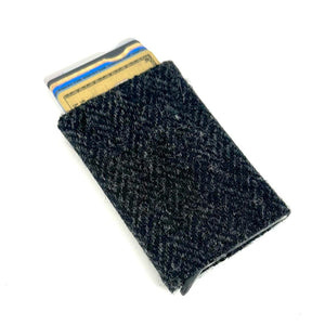 Angled view: Harris Tweed Pop-Up Card Holder in charcoal with cards visible, showcasing the pop-up mechanism.