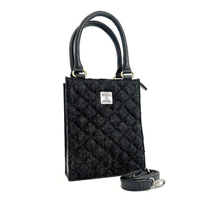 Angled view: Harris Tweed Mini Tote Bag in Charcoal, showcasing the quilted design and crossbody strap.