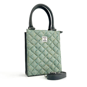 Angled view: Harris Tweed Mini Tote Bag in Turquoise, showcasing the quilted design and crossbody strap.