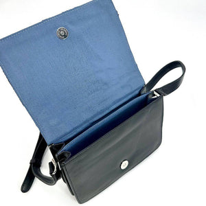 Angled view: Harris Tweed Quilted Shoulder Bag in blue, open to showcase the interior and black vegan leather.