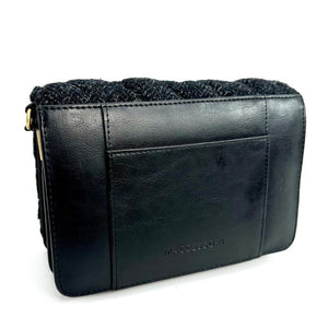 Back view: Harris Tweed Quilted Shoulder Bag in charcoal, focusing on the black vegan leather trim.