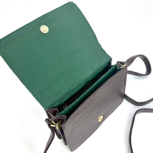 Angled view: Harris Tweed Quilted Shoulder Bag in country green, open to showcase the interior and brown vegan leather.