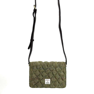 Strap view: Harris Tweed Quilted Shoulder Bag in country green with strap extended, showcasing the adjustable length.