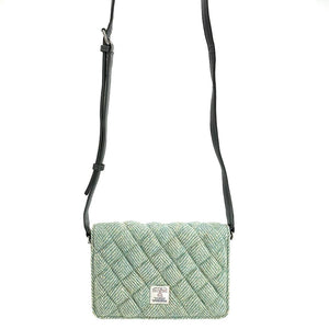 Strap view: Harris Tweed Quilted Shoulder Bag in turquoise with strap extended, showcasing the adjustable length.