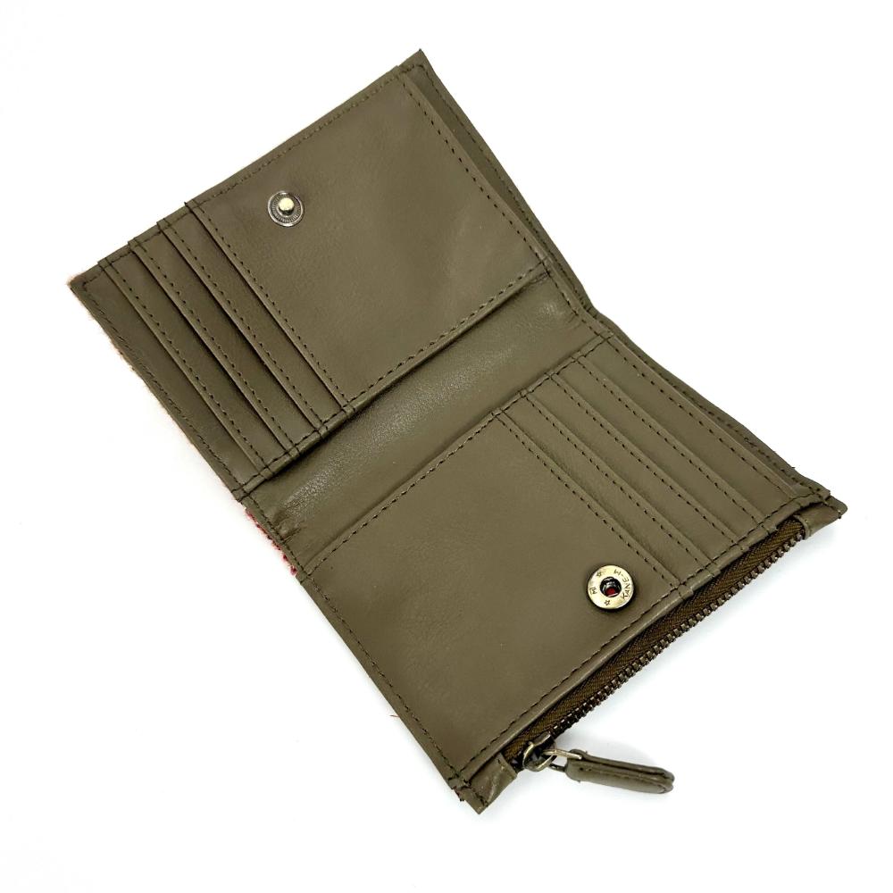 Angled view: Harris Tweed Slim Purse in maple, open to showcase the interior and card slots.
