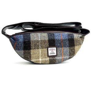 Front view: Harris Tweed Sling Bag in blue & brown, highlighting the bag's dimensions, vegan leather trim and Harris Tweed Orb trademark badge.