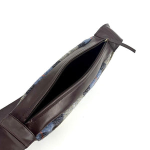 Angled view: Harris Tweed Sling Bag in blue and brown , open to showcase the interior and brown vegan leather.