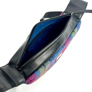 Angled view: Harris Tweed Sling Bag in pink and blue, open to showcase the interior and black vegan leather.