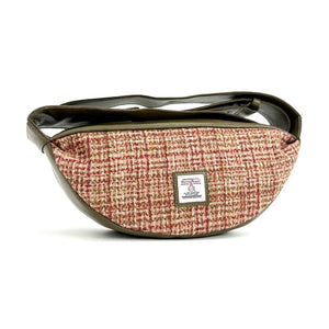 Front view: Harris Tweed Sling Bag in maple, highlighting the bag's dimensions, vegan leather trim and Harris Tweed Orb trademark badge.