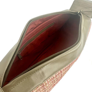 Angled view: Harris Tweed Sling Bag in maple, open to showcase the interior and olive vegan leather.