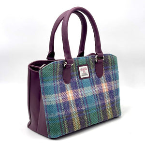 Harris Tweed Top Handle Bag in Green and Purple Tweed, featuring a purple vegan leather trim. 