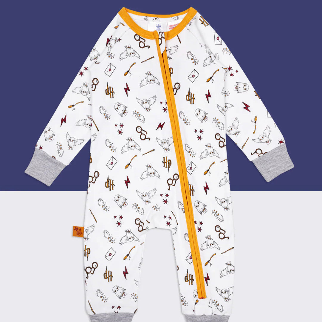 Flat lay of Harry Potter™ Hedwig romper playsuit with all-over print of Hedwig, wands, and HP logo.