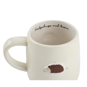 Close-up of hedgehog stoneware mug showing inner printed slogan.