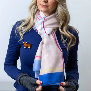 Close-Up of a model wearing the Scarf & Hairy Coo Pin – A detailed view of the Highland Cow Scarf - Thistle, elegantly paired with the included handcrafted Highland cow pin, adding a charming Scottish touch.