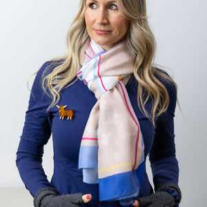 Model Wearing the Scarf Loosely Draped – A woman stylishly draping the Highland Cow Scarf - Thistle over her shoulders, highlighting its lightweight fabric and elegant Scottish design.