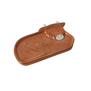 Side angle of the Highland Cow tea tidy showing its glossy finish.