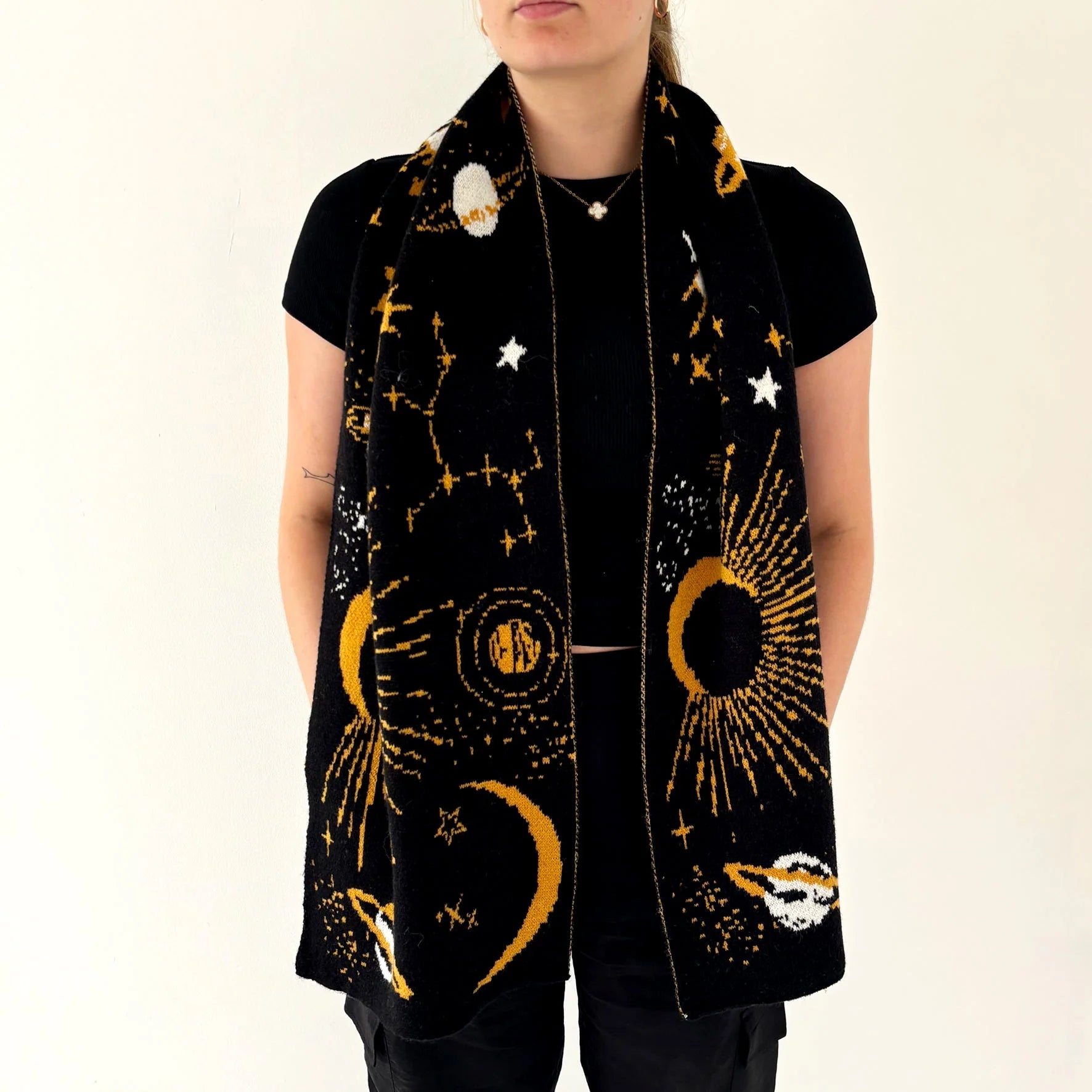 Person wearing the After Dark Black Scarf showing a full view of the starry gold and white planetary pattern across both panels.
