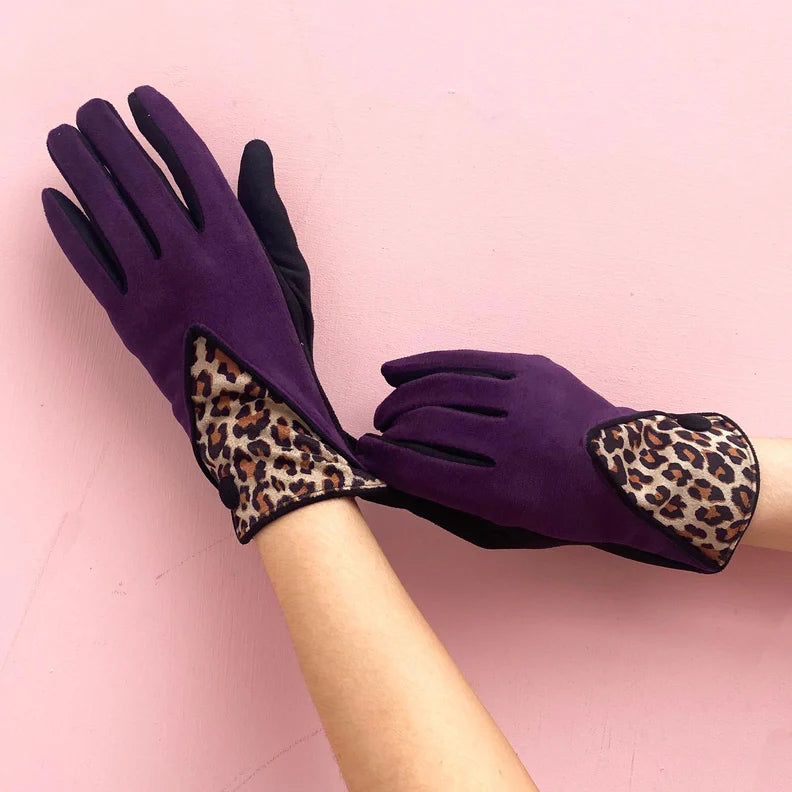 Model adjusting berry suedette gloves featuring bold leopard print accents.