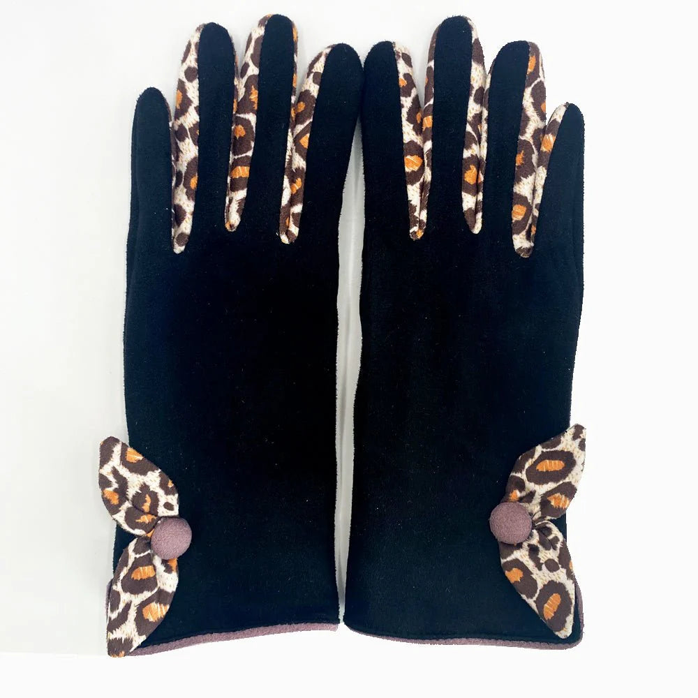 Flat lay of Animal Print Purple Leopard Gloves with leopard print bow detail on white background.