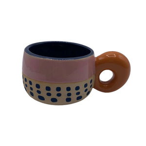 Bloc Cup product image with pink glazed top, navy dot pattern on unglazed base, and looped orange handle.