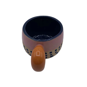 Overhead view of Bloc Cup showing navy blue glazed interior and orange handle.
