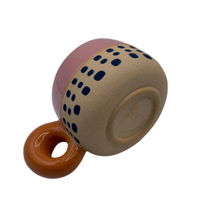 Underside view of Bloc Cup highlighting ceramic base and abstract navy dot design.