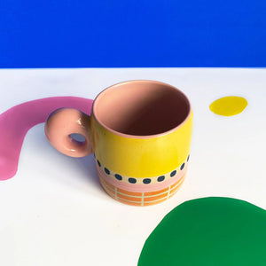 Overhead view of Bloc Mug with pink glazed interior and bold colour-block exterior.