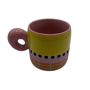 Front angle of Bloc Mug with pink handle and yellow upper half.