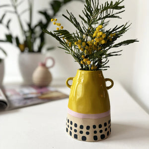 Front view of Bloc Yellow Vase showing curved neck and pastel colour blocks.