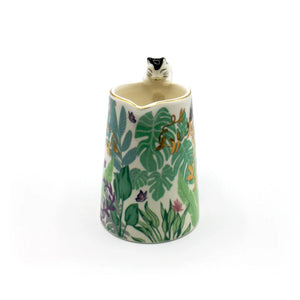 Top-down view of the Boulevard Cat Jug showing cat peeking inside, gold rim detail, and vibrant leaf pattern with butterflies.