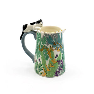 Side angle of the Boulevard ceramic jug with jungle-inspired print, showing the cat detail on the curved blue handle.
