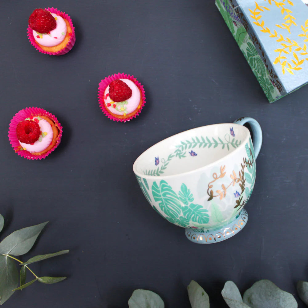 Boulevard Greenhouse porcelain cup with foliage design styled alongside raspberry cupcakes and gift box.