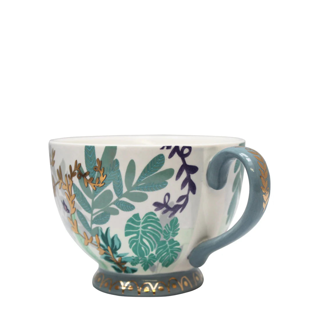 Side profile of Boulevard Greenhouse cup with gold vine details and tropical leaf pattern.