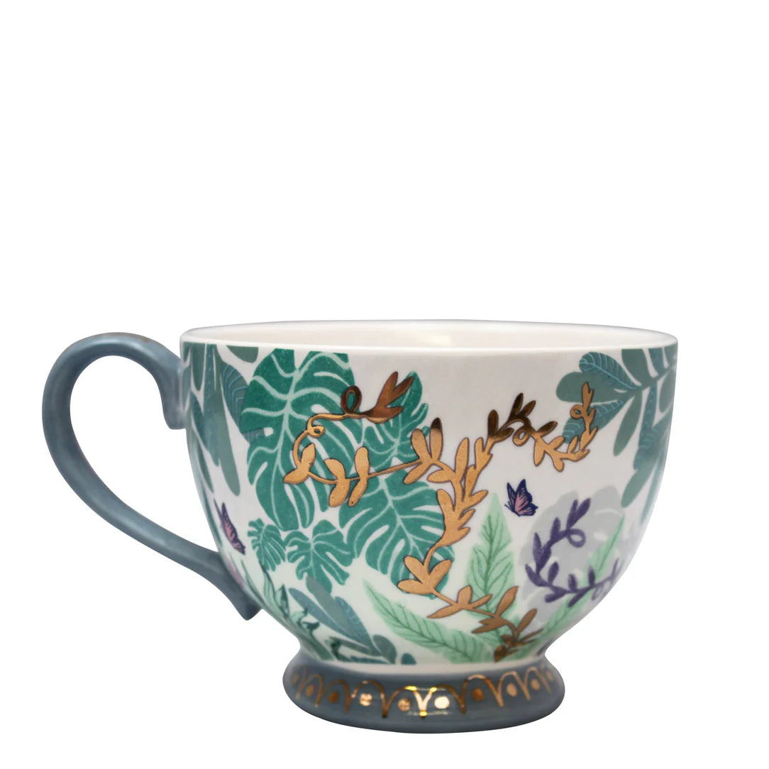 Porcelain foliage mug with blue handle and intricate botanical design.