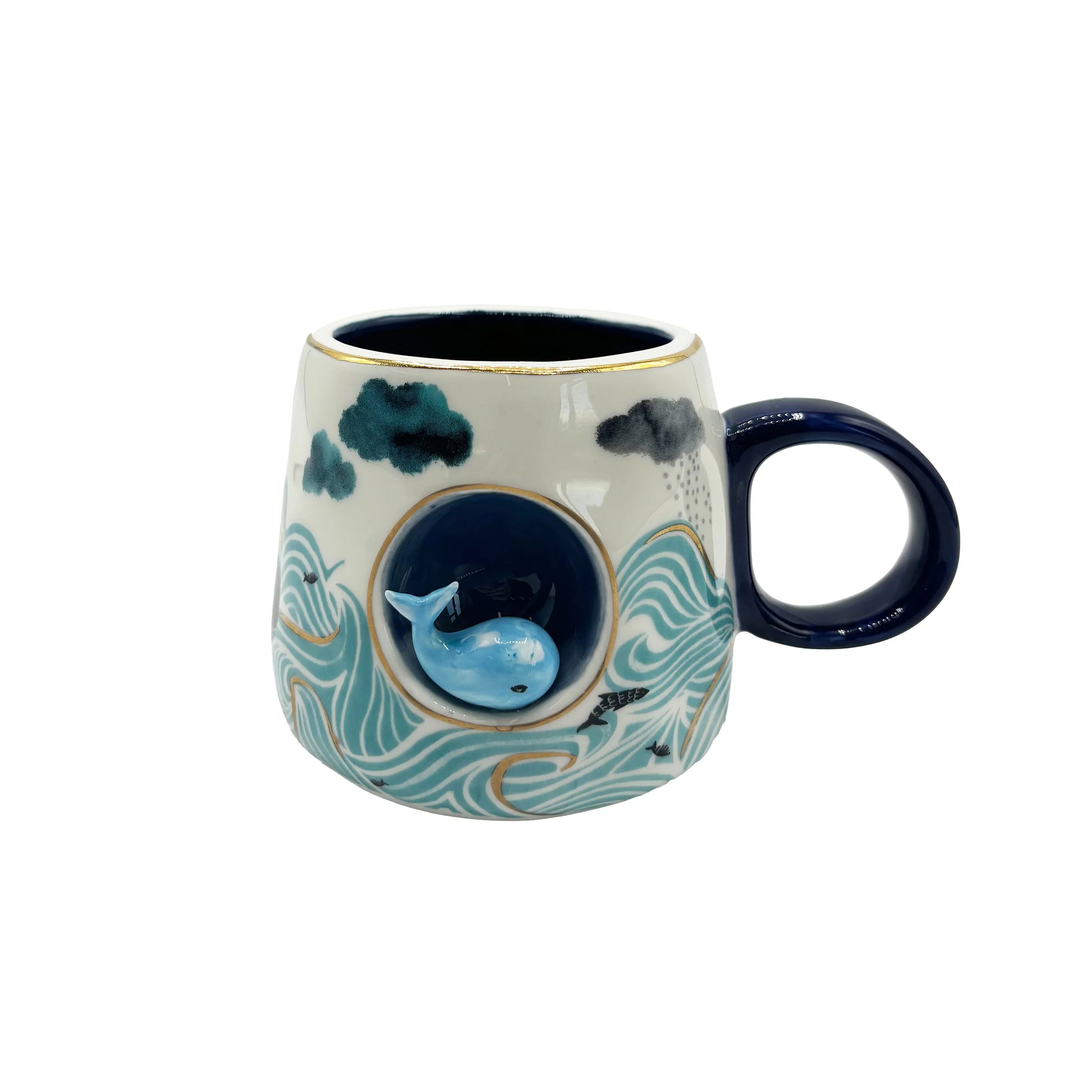 Front view of whale-themed ceramic mug featuring raised 3D whale detail and gold accents.