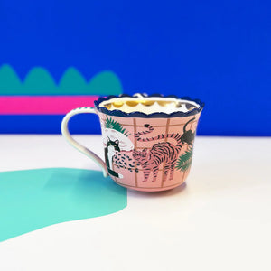 Reverse side of Catnip Cat Cup featuring multiple illustrated cats and tropical foliage.