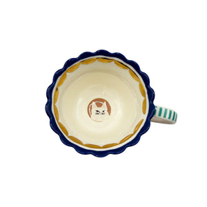 Top-down view of Catnip Cat Cup showing cat face illustration inside and gold rim detail.