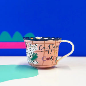 Front view of Catnip Cat Cup with ‘Caffeine & Cats’ text and cheetah illustration on a pink grid background.