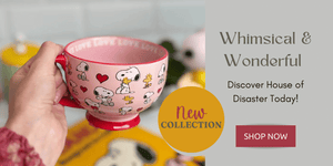   A hand holding a pink Snoopy-themed cup from the House of Disaster collection, with a stylish “New Collection” banner and “Shop Now” button on the right. 