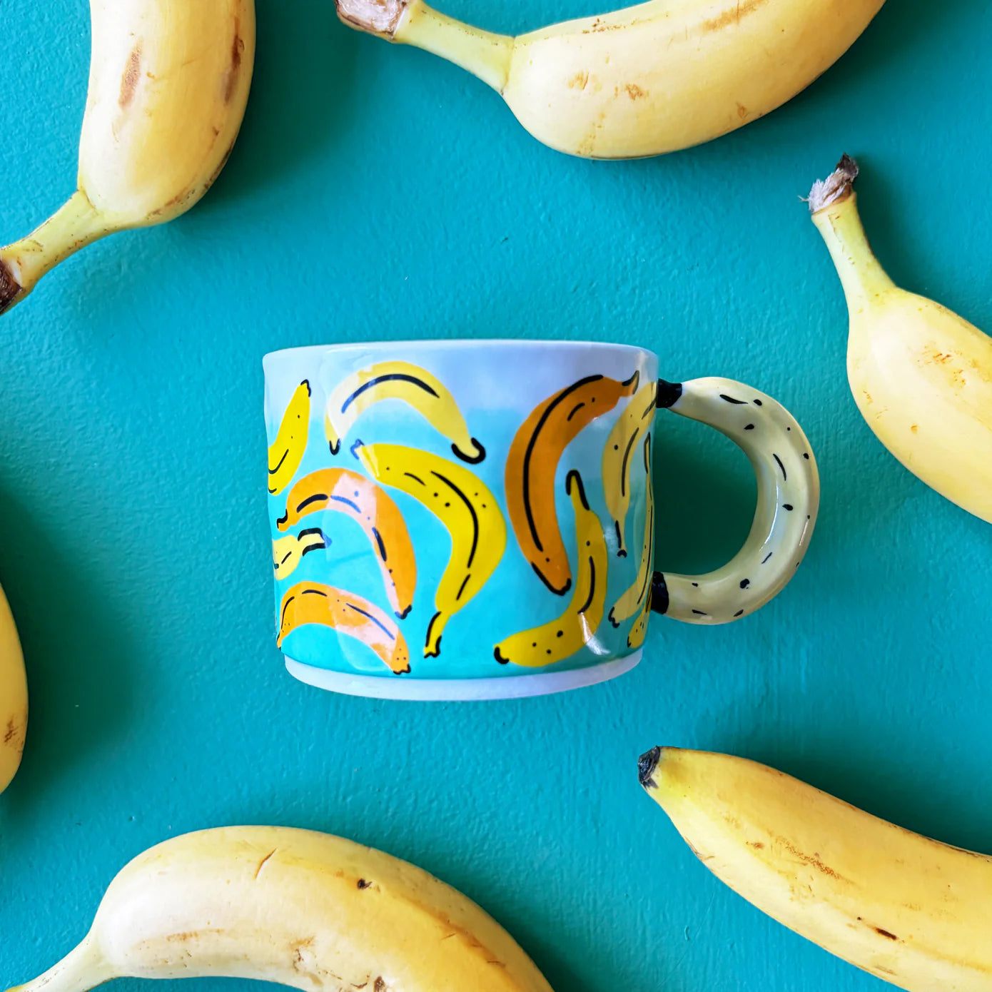 Back view of Fruity Banana Cup showing full wraparound banana pattern and detailed banana handle on a clean white background.