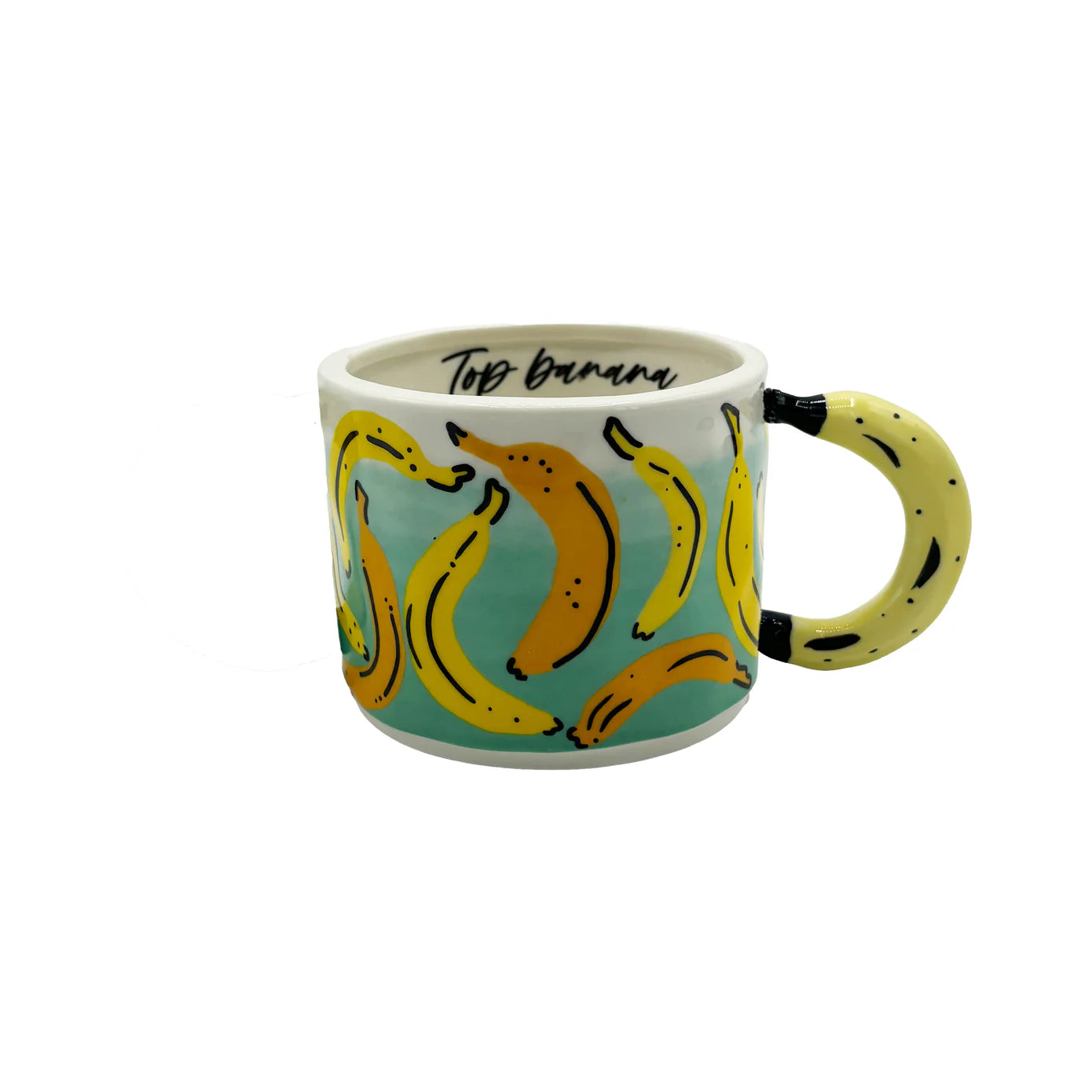 Side angle of ceramic banana mug with tropical yellow banana illustrations and quirky curved banana-shaped handle.