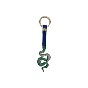 Studio shot of snake keyring with printed green snake design, gold ring, and blue strap.