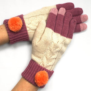 Pair of Loop Cream Gloves in cream and berry knit with orange pom-pom cuffs, shown worn on hands.