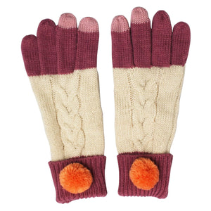 Loop Cream Gloves laid flat, featuring cream cable knit, berry fingertips, and bright orange pom-pom cuffs.