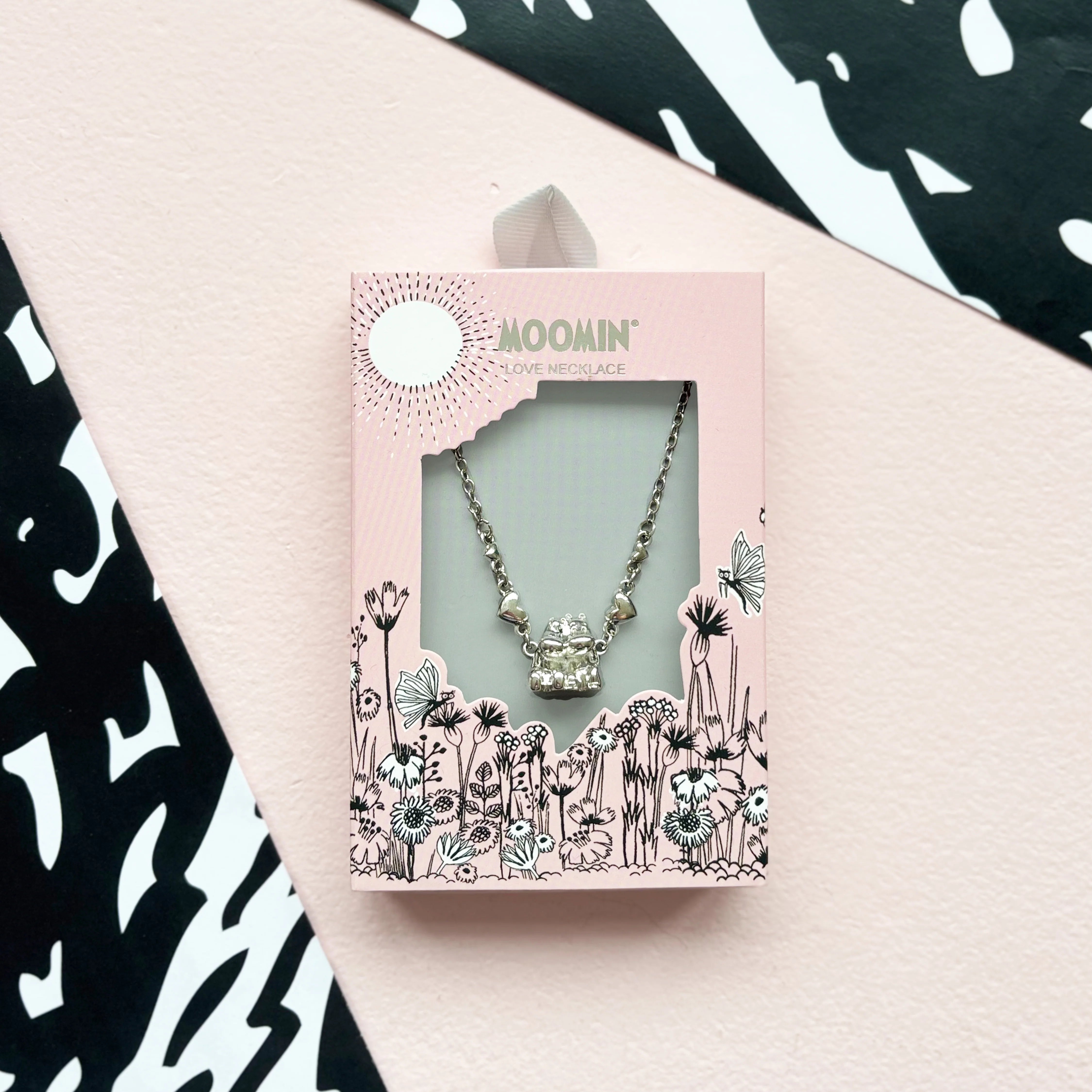 Moomin Love Necklace in pink illustrated gift box with floral design and display window.