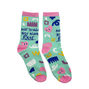 Pair of socks displayed side by side with matching abstract designs and cheeky message front and centre.
