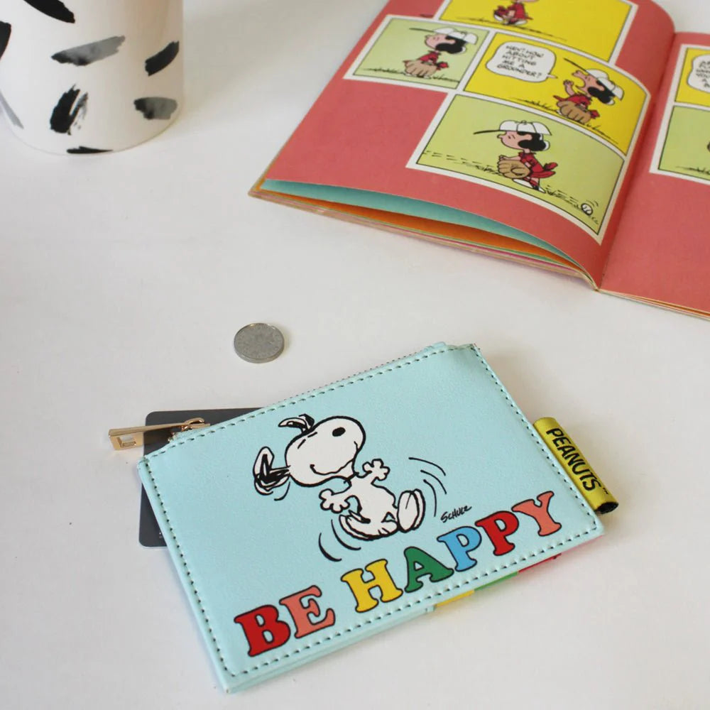 Light blue Snoopy zip purse with ‘Be Happy’ rainbow lettering and dancing Snoopy illustration.