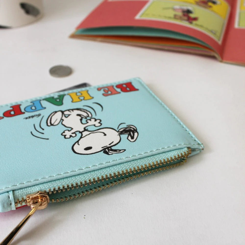 Close-up of Snoopy zip purse gold zipper and dancing Snoopy artwork.