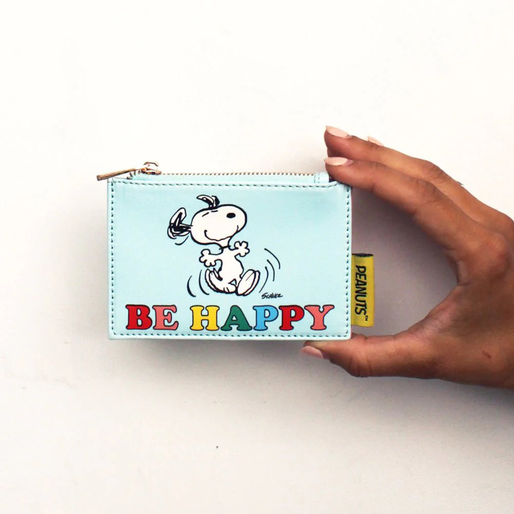 Hand holding Peanuts zip purse with cheerful Snoopy design.